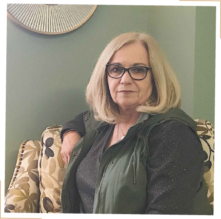 woman with glasses sitting on chair in green room - Lisa Bond Coaching | DBT skills and solutions for borderline personality disorder (BPD) and high emotional sensitivity