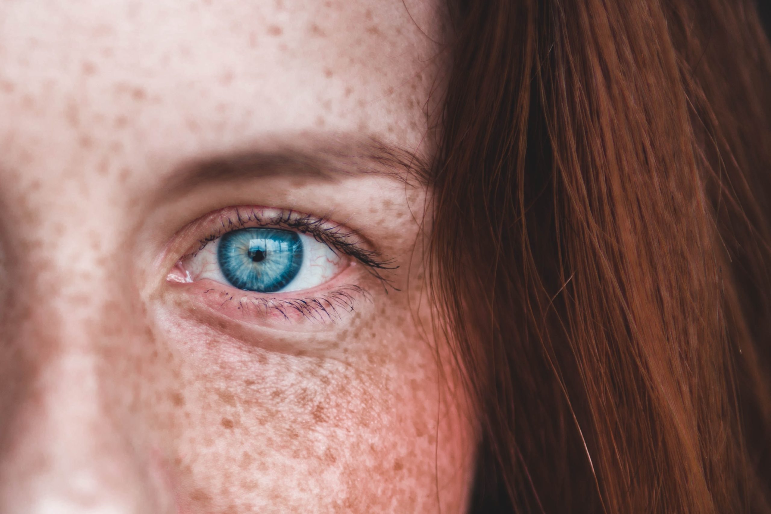 close up of a red haired woman's blue eye